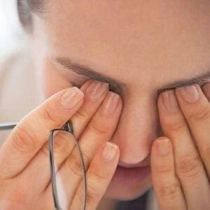 Woman rubbing eyes due to eye strain