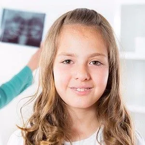 young brown haired girl smiling in orthodontic office, early orthodontic treatment Simi Valley, CA & Thousand Oaks, CA