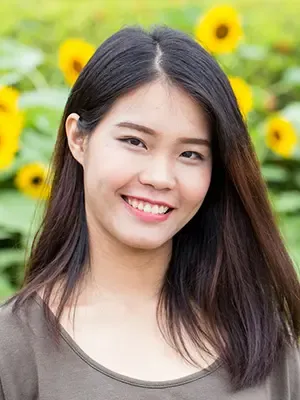 young woman outside by sunflowers smiling nice teeth, dental exams and teeth cleaning Colonial Heights dentist