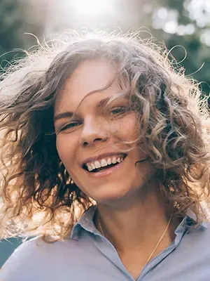 woman outdoors smiling, gum disease Colonial Heights, VA dentist