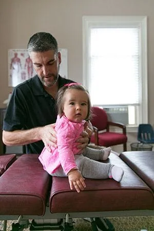 Dr. Lavoie adjusting baby
