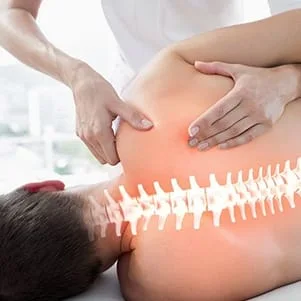 Illuminated spine of patient receiving chiropractic care from chiropractor