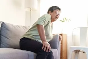 Old woman suffering from joint pain due to Osteoarthritis