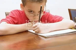 stock-photo-5184764-young-boy-reluctant-to-do-homework.jpg