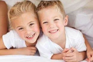blond girl and boy hugging and smiling, pediatric dentist Chino Hills, CA