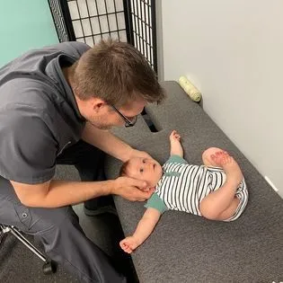 DR. Lozier adjusting baby