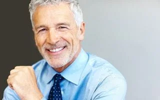 gray haired man in dress shirt and tie smiling, Full Mouth Restoration San Diego, CA cosmetic dentistry