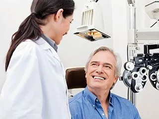 Girl Eye Doctor Smiling At Male Patient In Eye Exam Room Chair- Ophthalmology Pensacola - Fifty Dollar Eye Guy 5328 N Davis Hwy Pensacola, FL 32503 <a href=