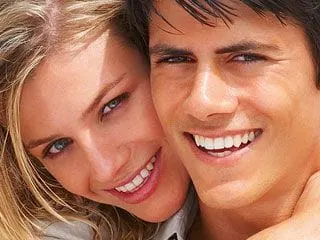 young blond woman smiling posing with dark haired attractive man, teeth whitening North York, ON teeth bleaching