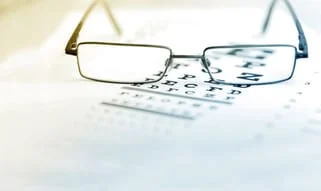 image of eye glasses on an eye chart. 