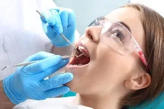 young girl mouth open getting dental work done by kids dentist Frederick, MD