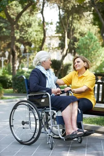 woman in wheelchair and caregiver