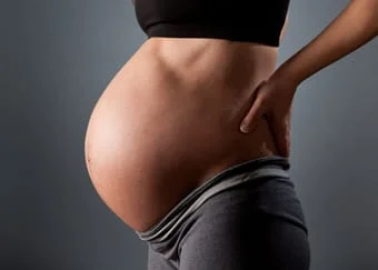 Side view of a pregnant woman's abdomen
