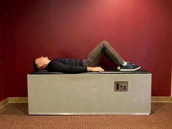 Man laying on intersegmental traction table