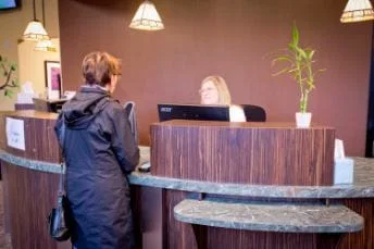 Image of woman talking to a receptionist