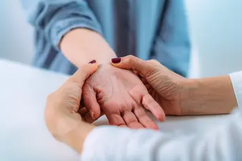 Doctor examining a patients hand due to carpal tunnel syndrome.