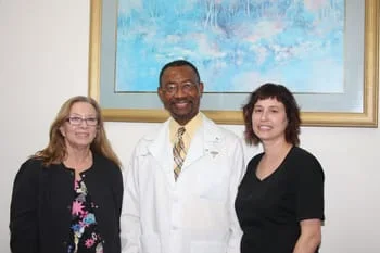 Dr. Vincent A. U. Oganwu, D.D.S. and two of his dental staff members in office, Olympia Fields dentist