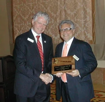 Dr Neil McLeod DDS awards Dr Mark Goldenberg a comemorative plaque 