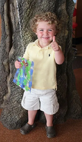 Boy in front of tree