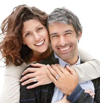 middle aged couple hugging smiling, nice teeth, dental implants Washington DC dentist