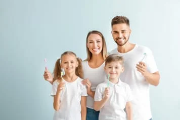 parents with young children holding toothbrushes, Family Dentist Placerville, CA