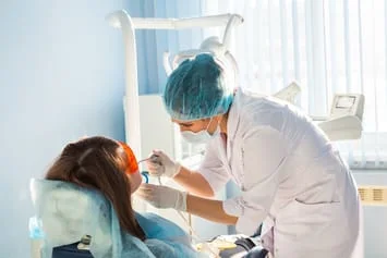 Photograph of dentist performing laser dentistry procedure, Brownsville, TX