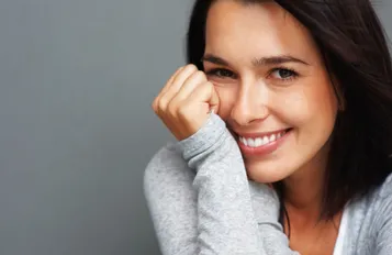 dark haired young woman smiling, nice white teeth after cosmetic dentistry Patchogue, NY
