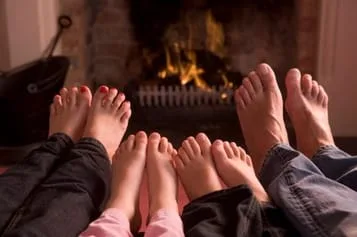 Feet by a fireplace