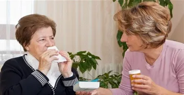 Woman assisting elderly woman