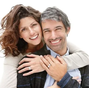 wife hugging husband, both smiling have nice white teeth, cosmetic dentistry Salem, OR dentist