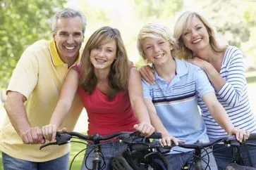 Family smiling and riding bikes