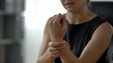 woman holding wrist