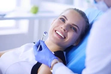 blond girl smiling sitting in dental chair, cosmetic dentistry Lake Worth, FL & Greenacres, FL dentist