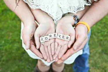 Couple cupping hands, in the center letter squares depicting the word Forever.. save your relationship with Marriage Counseling Therapists in Miami