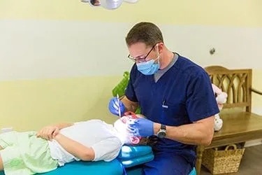 Dr. Simmons Cleaning a Child's Teeth in Pensacola, FL