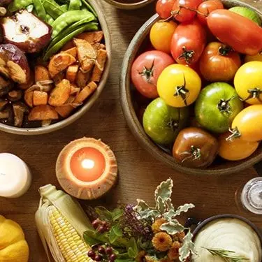 Women with nutritious food in kitchen