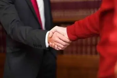 Two people shaking hands in an agreement