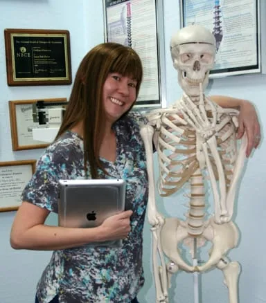 Angela with her arm around a skeleton we call Mr. Bones