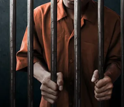 inmate behind bars image