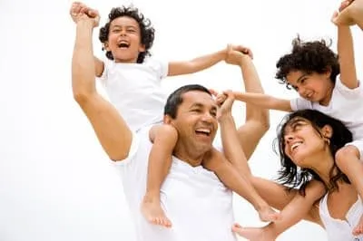 family of 4 laughing together. mother, daughter, young son and daughter