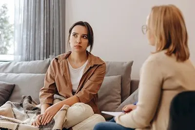 Woman with ADHD appearing distracted during therapy session