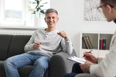 Male client reflecting on personal strengths and well-being through positive psychology.