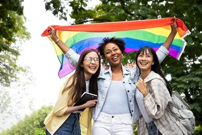 lgbt community raising pride flag