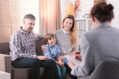 Parent and child engaging in a therapy session focused on managing ADHD symptoms.