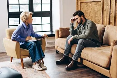 Adult man receiving autism-focused therapy in a clinical setting