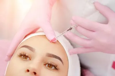 Procedure of Botox on face of a woman