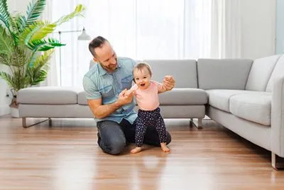 Man teaching his child to walk