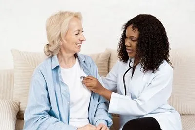 Primary care physician examining patient's heart