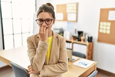 Woman showing signs of anxiety inside office environment