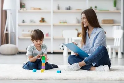 Child engaging in play therapy with therapist